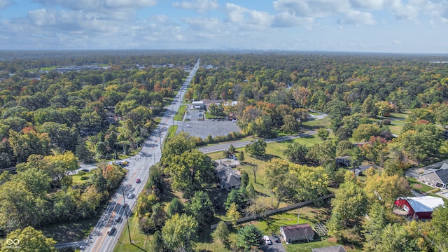 birds eye view of property with a view of trees