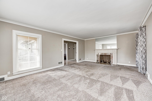 unfurnished living room featuring baseboards, a fireplace, carpet flooring, and crown molding