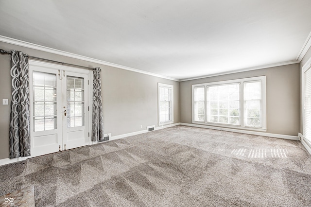 unfurnished room featuring carpet floors, ornamental molding, visible vents, and baseboards