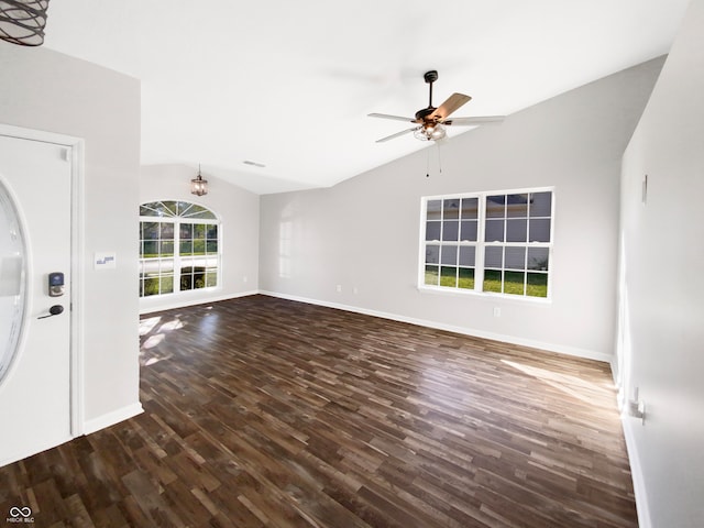 unfurnished living room featuring ceiling fan with notable chandelier, vaulted ceiling, and dark hardwood / wood-style floors