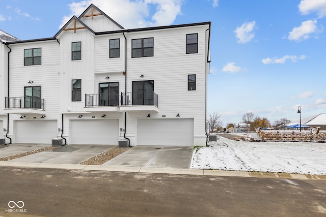 view of front of home featuring central air condition unit and a garage