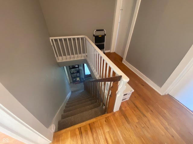 stairs featuring wood-type flooring