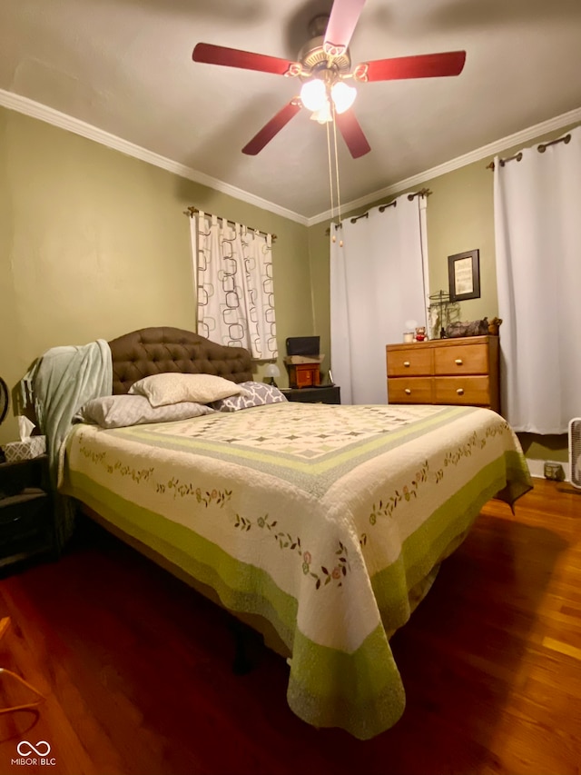 bedroom with crown molding, hardwood / wood-style flooring, and ceiling fan