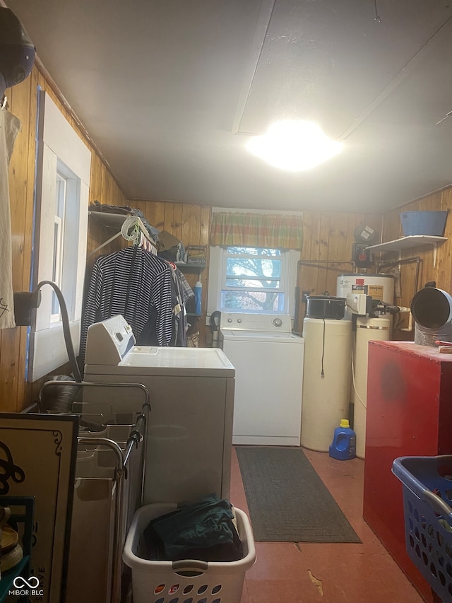 laundry room featuring washing machine and dryer and wooden walls