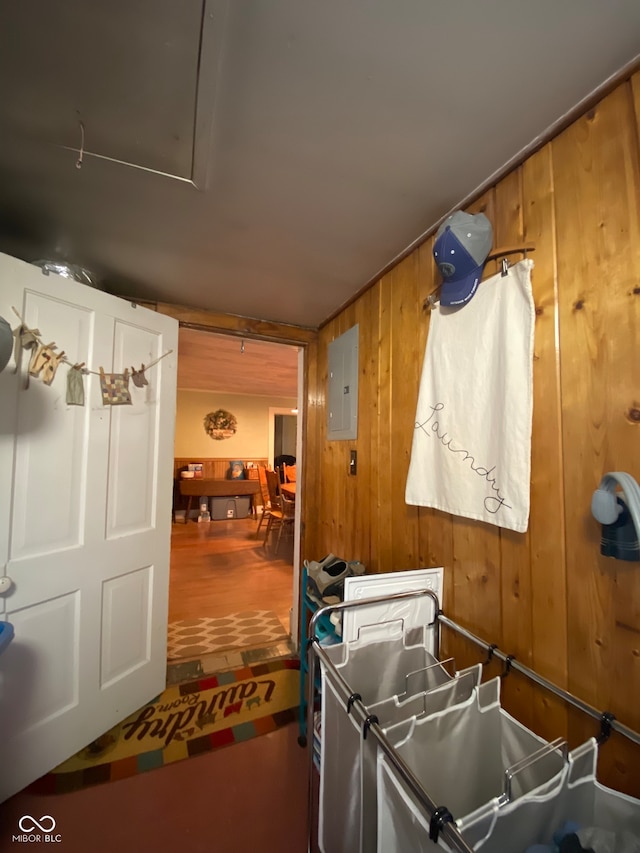 interior space with electric panel and wooden walls