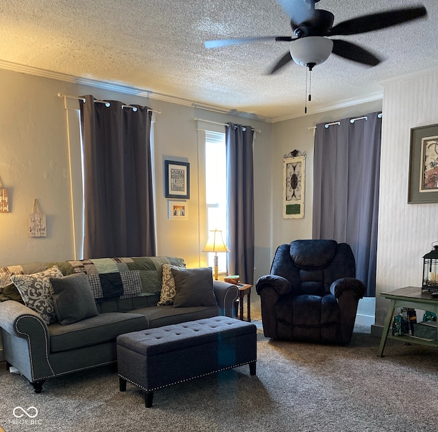 living room with ornamental molding, ceiling fan, carpet floors, and a textured ceiling