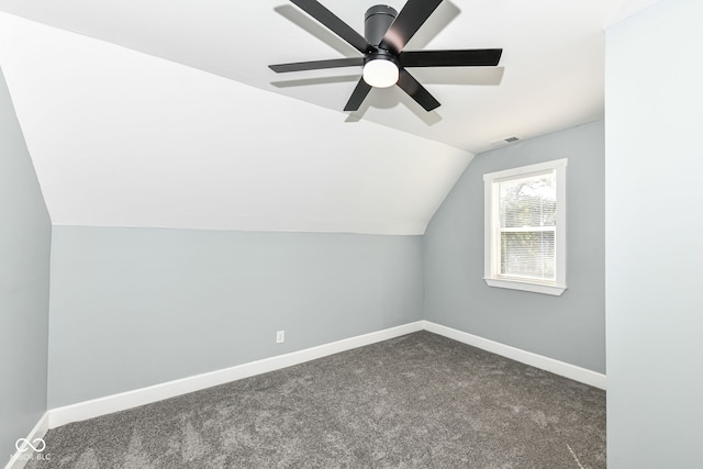 bonus room featuring lofted ceiling and dark carpet