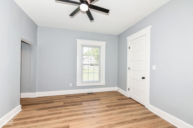 empty room with light wood-type flooring and ceiling fan