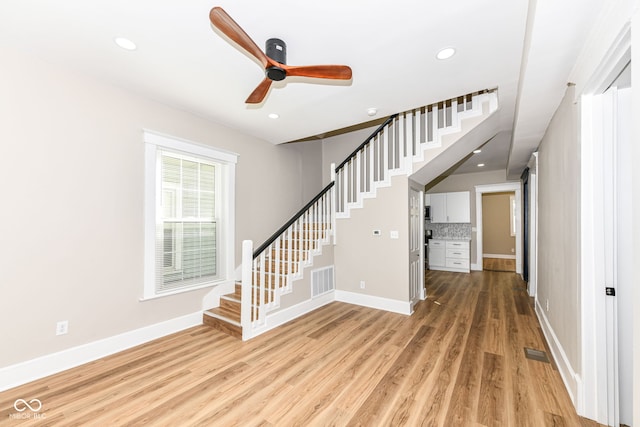 interior space with wood-type flooring and ceiling fan