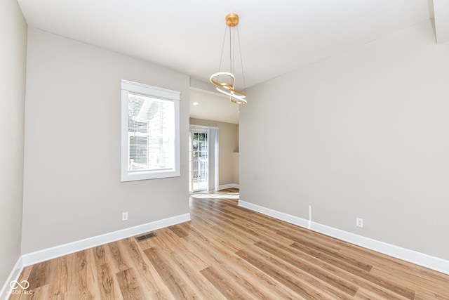 unfurnished room with light hardwood / wood-style flooring