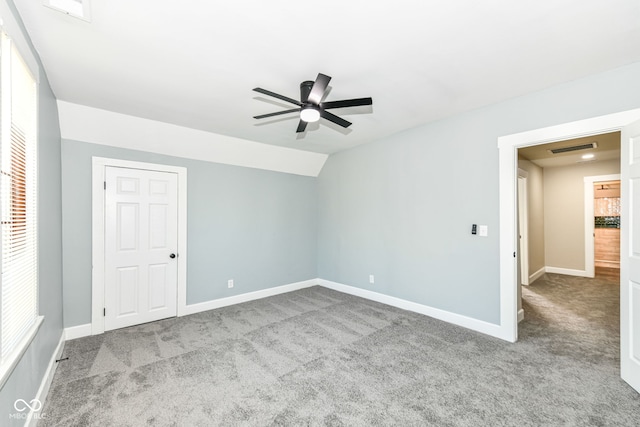 carpeted spare room with lofted ceiling and ceiling fan