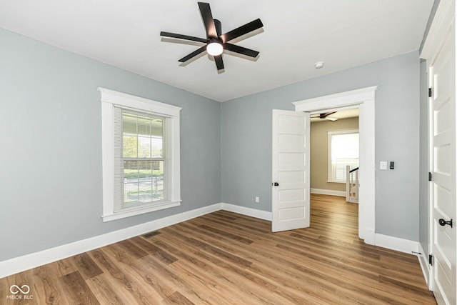 unfurnished bedroom with ceiling fan and wood-type flooring