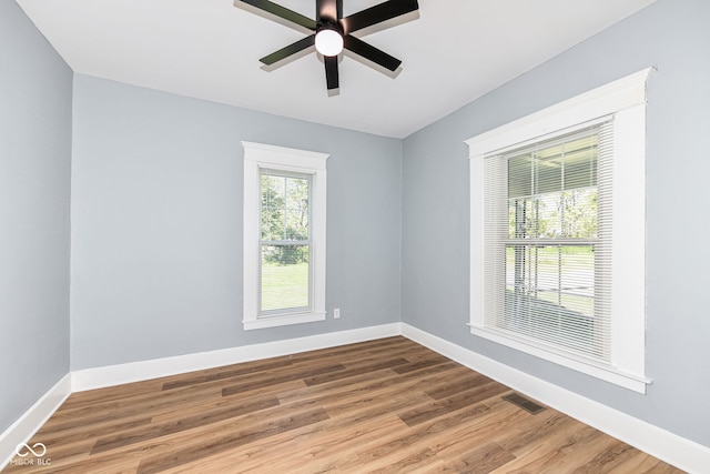 empty room with ceiling fan and hardwood / wood-style floors