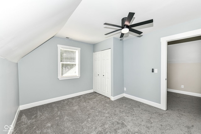 bonus room with lofted ceiling, dark carpet, and ceiling fan