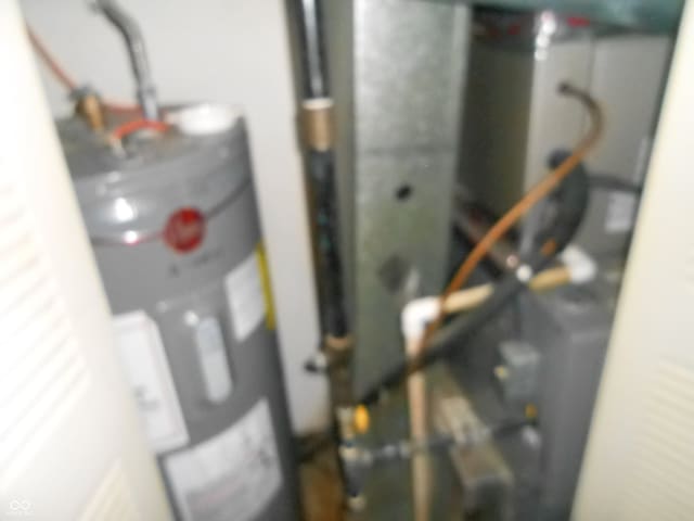 utility room featuring water heater