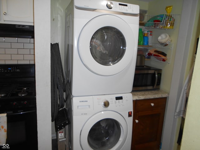 washroom featuring stacked washer and dryer