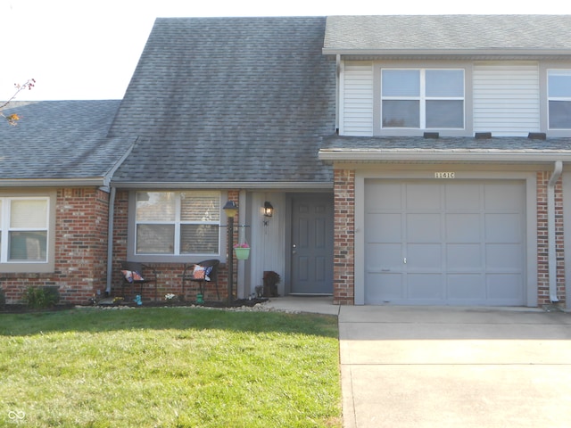 view of front of house featuring a garage and a front lawn