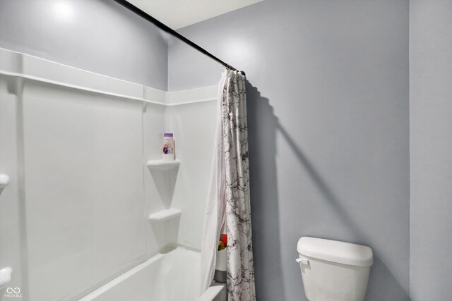 bathroom with toilet and shower / bath combo