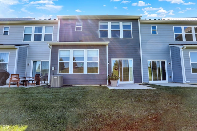 rear view of house with a patio, a yard, and central air condition unit