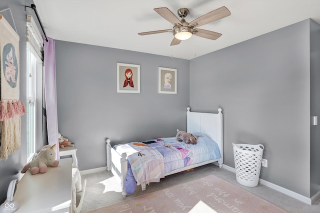 bedroom featuring carpet flooring, multiple windows, and ceiling fan