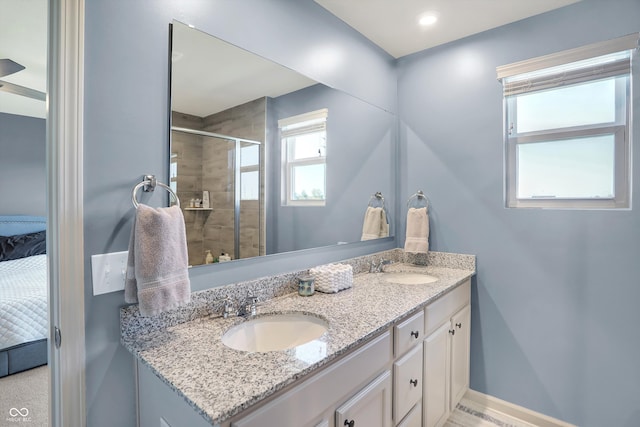 bathroom with an enclosed shower and vanity