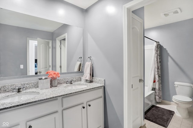 full bathroom featuring toilet, vanity, shower / bath combo with shower curtain, and tile patterned floors