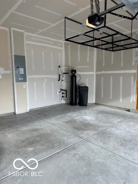 garage with electric panel and a garage door opener