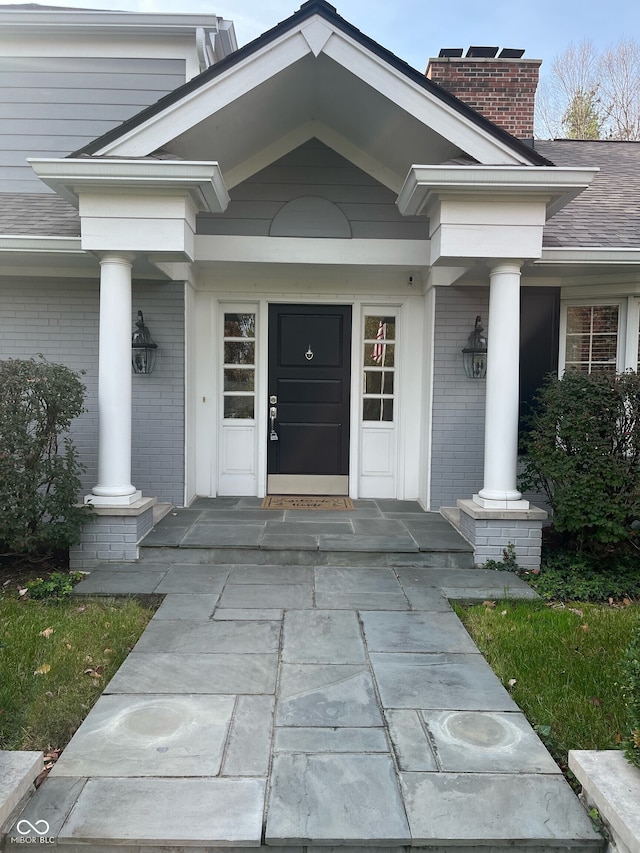 view of exterior entry with a porch