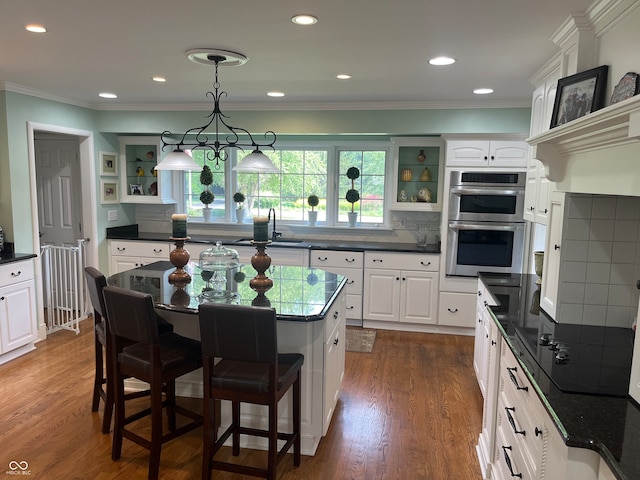 kitchen featuring white cabinetry, tasteful backsplash, double oven, and dark hardwood / wood-style flooring