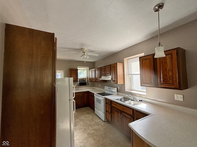 kitchen with ceiling fan, pendant lighting, sink, white appliances, and a textured ceiling