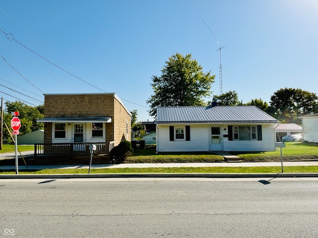 bungalow featuring a front lawn and a porch