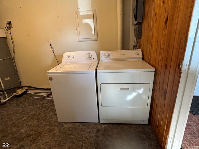 washroom featuring wooden walls and washer and dryer