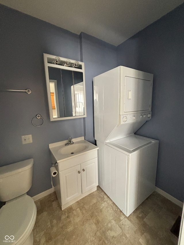 interior space featuring stacked washer and dryer and sink