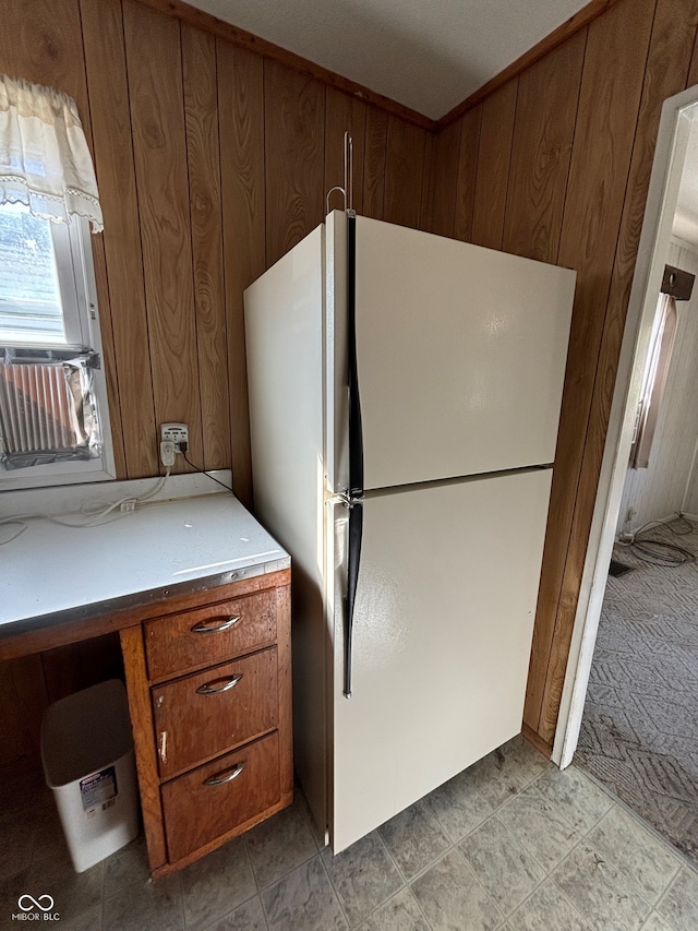 kitchen with cooling unit, white fridge, and wooden walls