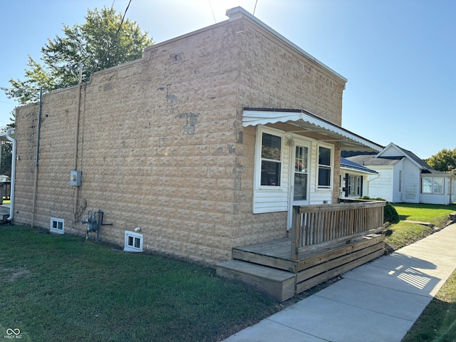 view of side of home featuring a yard