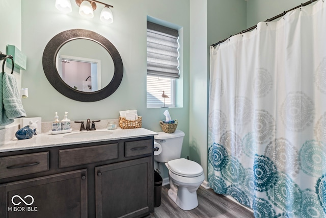 bathroom featuring a shower with curtain, hardwood / wood-style flooring, vanity, and toilet