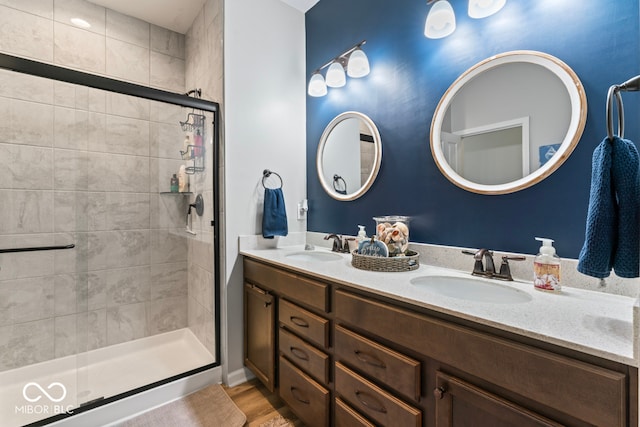 bathroom featuring walk in shower, vanity, and hardwood / wood-style floors