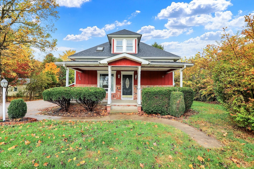 view of front of property with a front yard and a porch