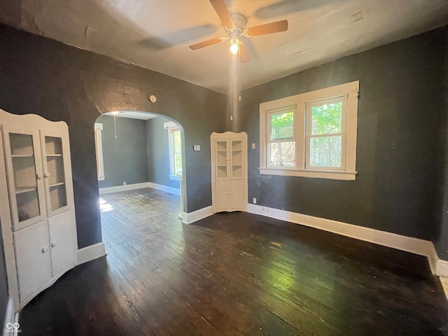 spare room featuring ceiling fan and dark hardwood / wood-style flooring