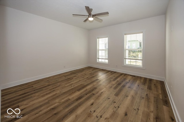 unfurnished room with dark hardwood / wood-style floors and ceiling fan