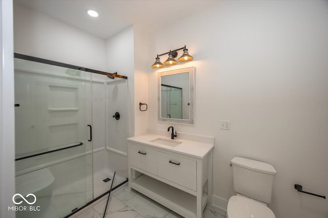 bathroom featuring vanity, toilet, and a shower with door