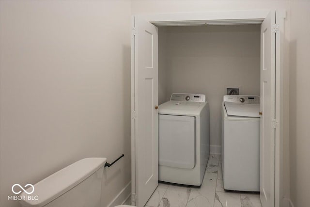 1666 Union St, Indianapolis, IN 46225 - clothes washing area featuring baseboards, independent washer and dryer, laundry area, and marble finish floor