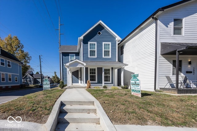 view of front of house featuring a front yard and a porch