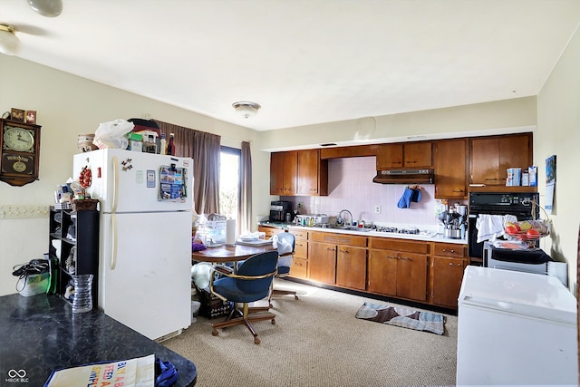 kitchen featuring light colored carpet, sink, white appliances, and tasteful backsplash