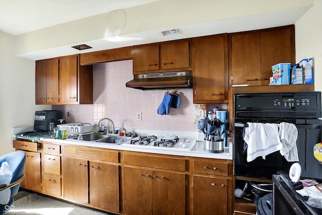 kitchen with black oven and backsplash