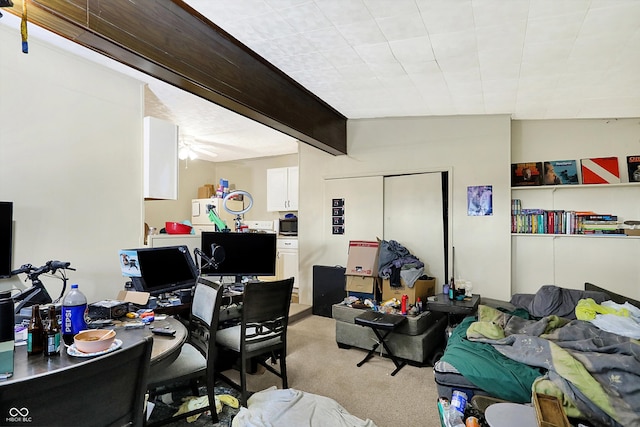 office space with light colored carpet, lofted ceiling with beams, and ceiling fan