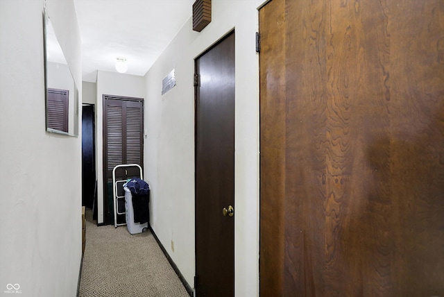 corridor featuring light colored carpet