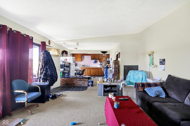 carpeted living room featuring lofted ceiling and sink