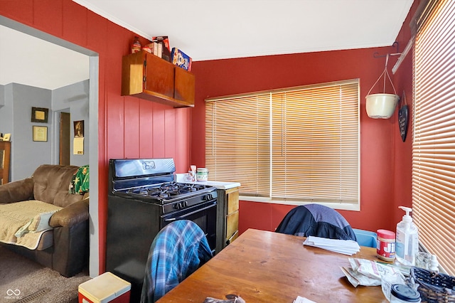 kitchen with black gas range oven and ornamental molding