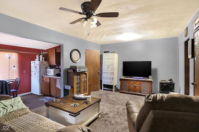 living room featuring dark carpet and ceiling fan